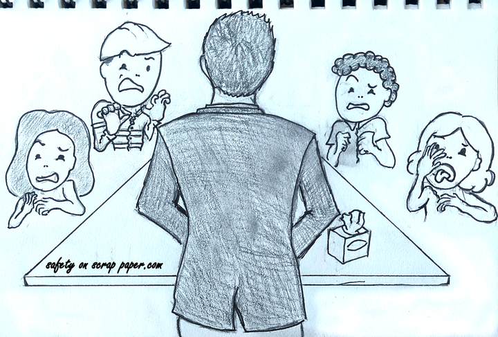 A notebook drawing of a person in a suit with their back towards the viewer in front of a meeting room table. There are four people in disgust looking at what the man is doing.